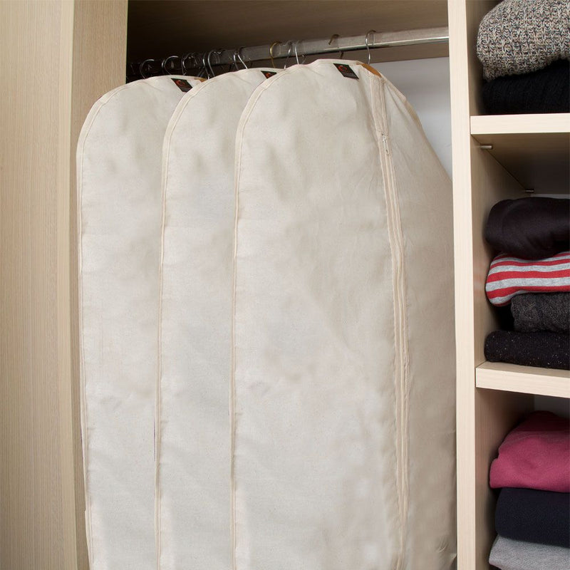 Cotton Dress Cover from Caraselle hanging on a rack in a closet with folded clothes on shelves.